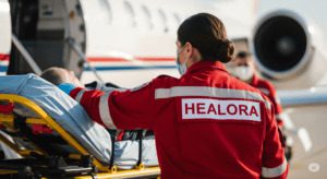 Home care patient on stretcher at airport ground ready for domestic or international flight transfer